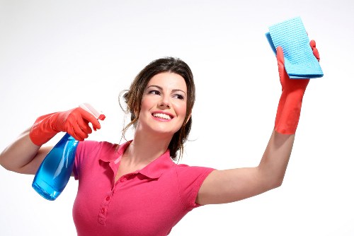 Professional cleaner using protective equipment during service